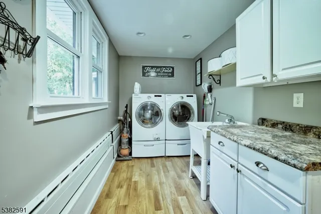 a bathroom with a granite countertop sink toilet a mirror a vanity and shower