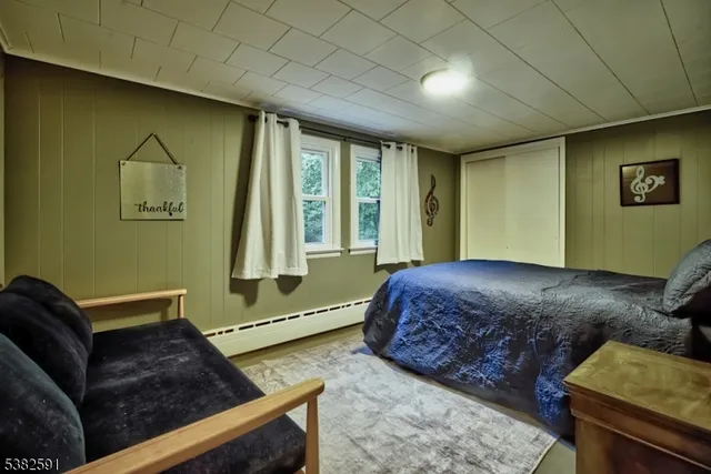 a bed sitting in a bedroom next to a cabinet
