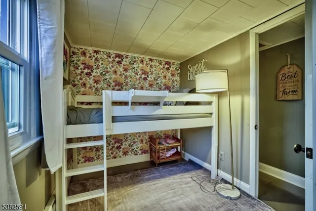 a bedroom with a bed and chair