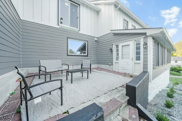 a backyard of a house with table and chairs