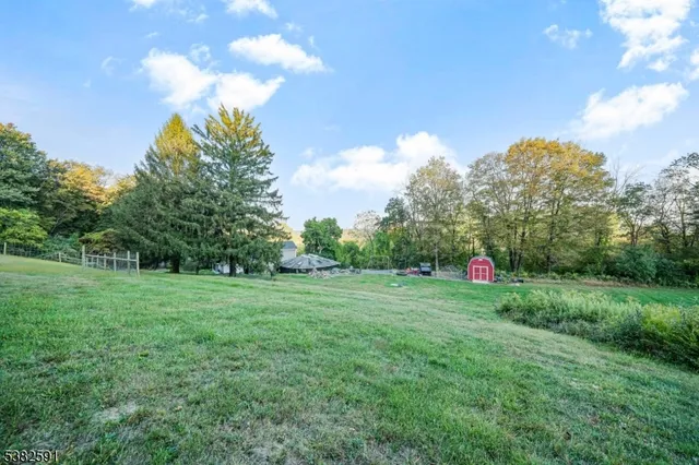 a view of a big yard with a house in the background