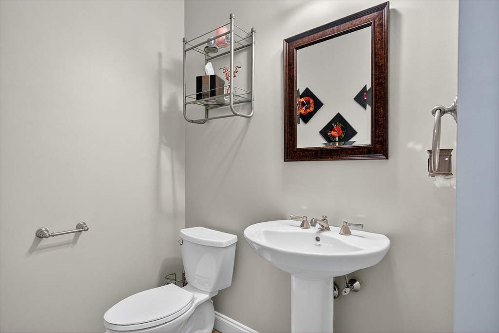 6 Colby Road Danvers, MA 01923 - Photo 14 of 42 a bathroom with a toilet sink and mirror