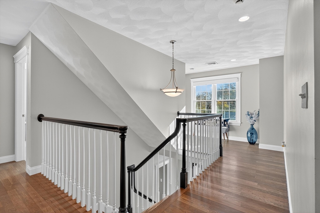 6 Colby Road Danvers, MA 01923 - Photo 19 of 42 a view of a hallway with wooden floor and stairs