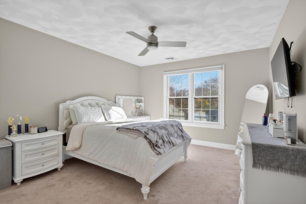 6 Colby Road Danvers, MA 01923 - Photo 25 of 42 a spacious bedroom with a bed and a large window