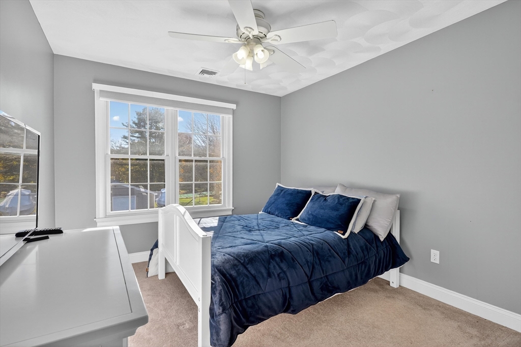 6 Colby Road Danvers, MA 01923 - Photo 26 of 42 a bed sitting in a bedroom next to a window