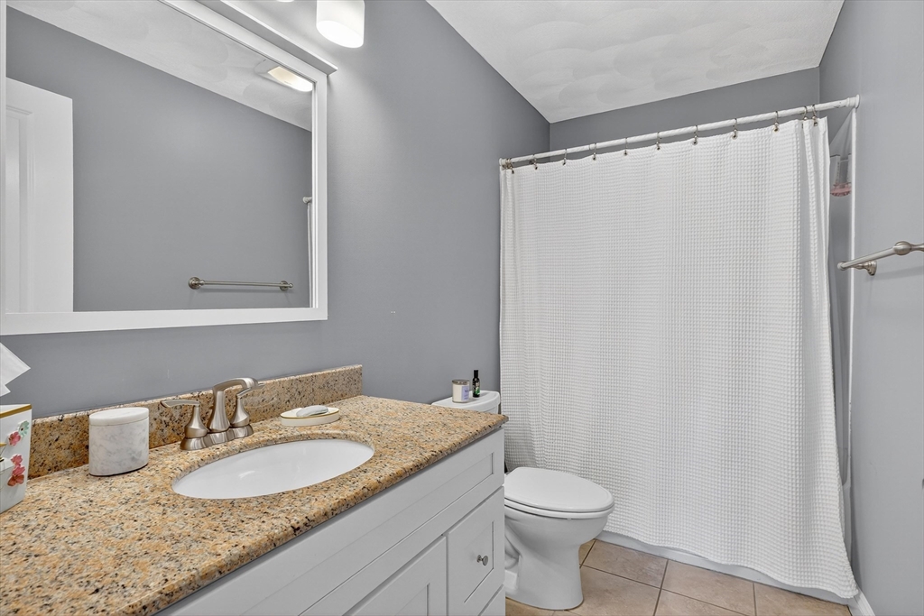 6 Colby Road Danvers, MA 01923 - Photo 28 of 42 a bathroom with a granite countertop sink and a mirror