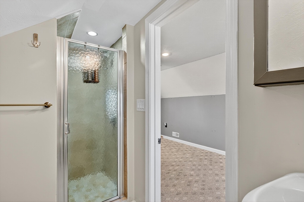 6 Colby Road Danvers, MA 01923 - Photo 33 of 42 a bathroom with a glass shower door