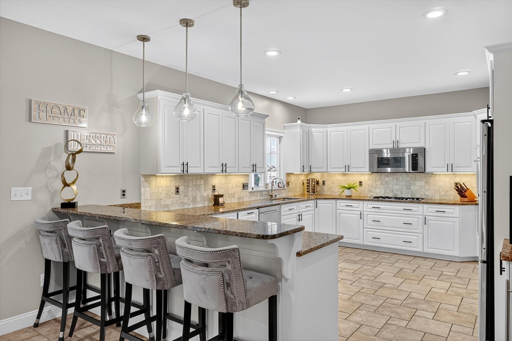 6 Colby Road Danvers, MA 01923 - Photo 4 of 42 a kitchen with granite countertop cabinets a counter space and stainless steel appliances