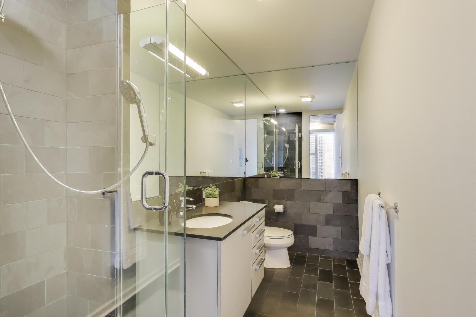 550 North St Clair Street, Unit 1303 Chicago, IL 60611 - Photo 13 of 20 a bathroom with a sink a toilet and shower