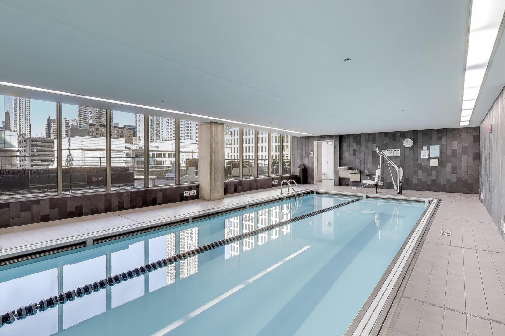 550 North St Clair Street, Unit 1303 Chicago, IL 60611 - Photo 18 of 20 a large white kitchen with kitchen island granite countertop a large window