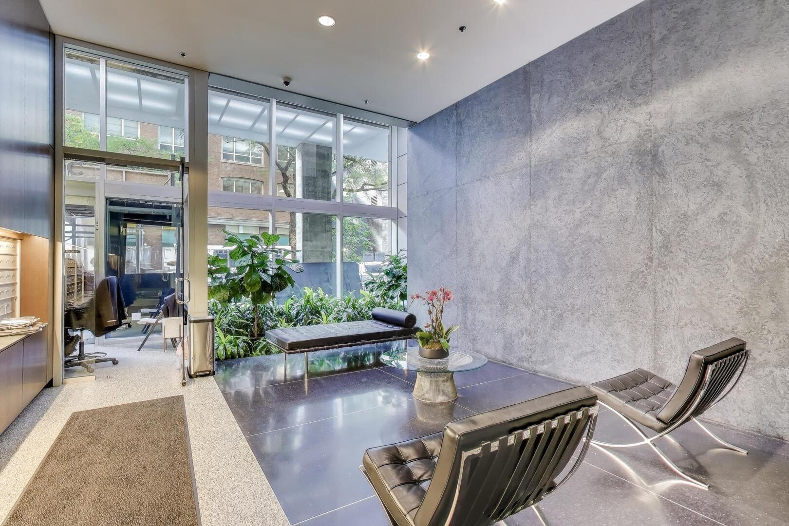 550 North St Clair Street, Unit 1303 Chicago, IL 60611 - Photo 5 of 20 a living room with furniture and potted plants