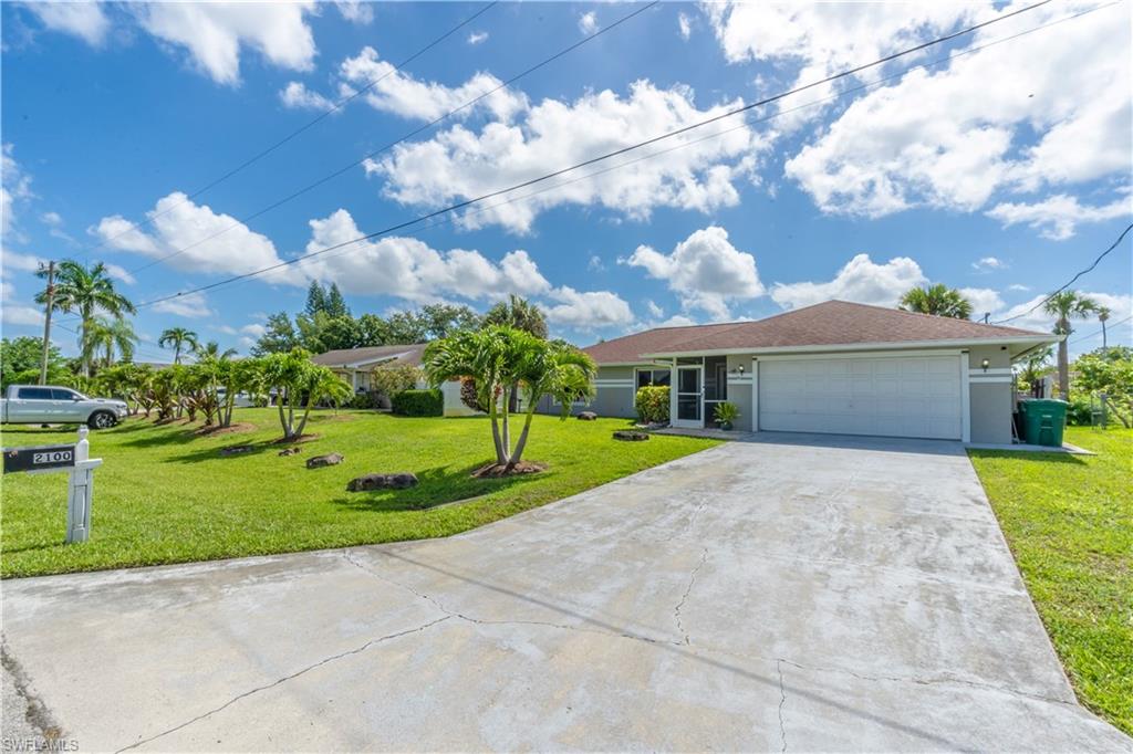 2100 55th Street Southwest Naples, FL 34116 - Photo 3 of 50 a front view of house with yard and green space