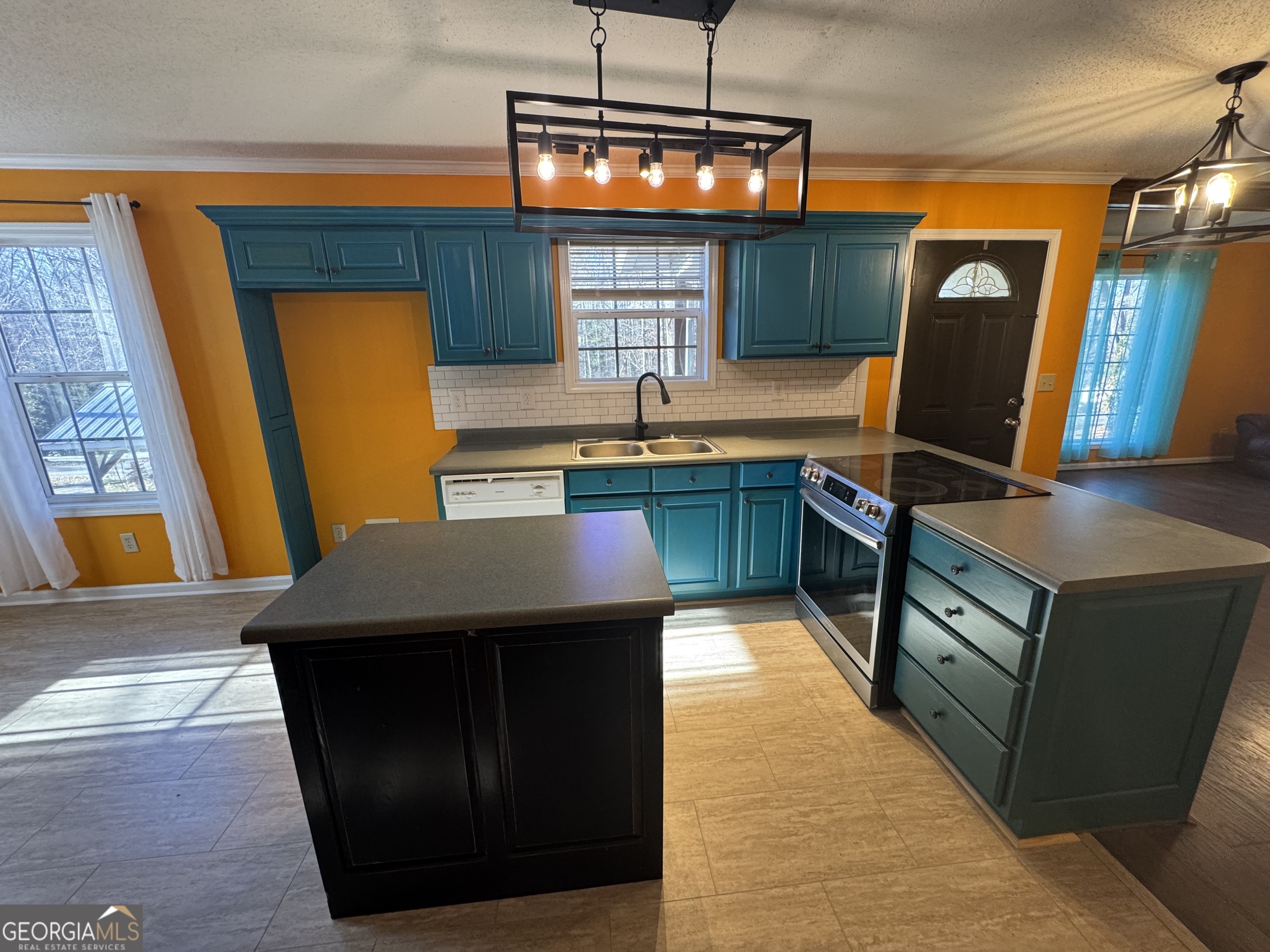 813 Normandy Trail Lavonia, GA 30553 - Photo 13 of 32 a kitchen with stainless steel appliances granite countertop a sink and a stove