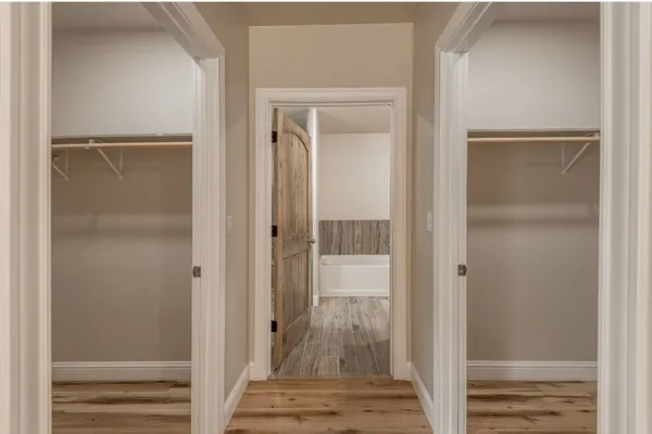 a view of walk in closet with empty racks