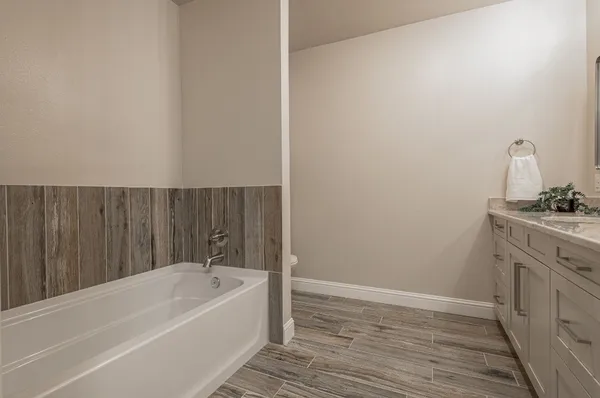 a bathroom with a granite countertop double vanity sink mirror and double