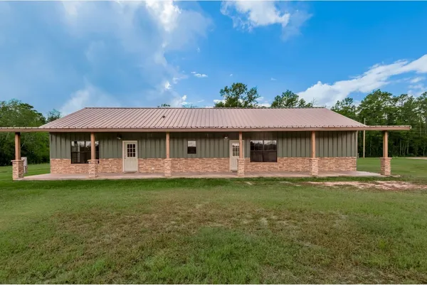 a view of a backyard of a house with a yard