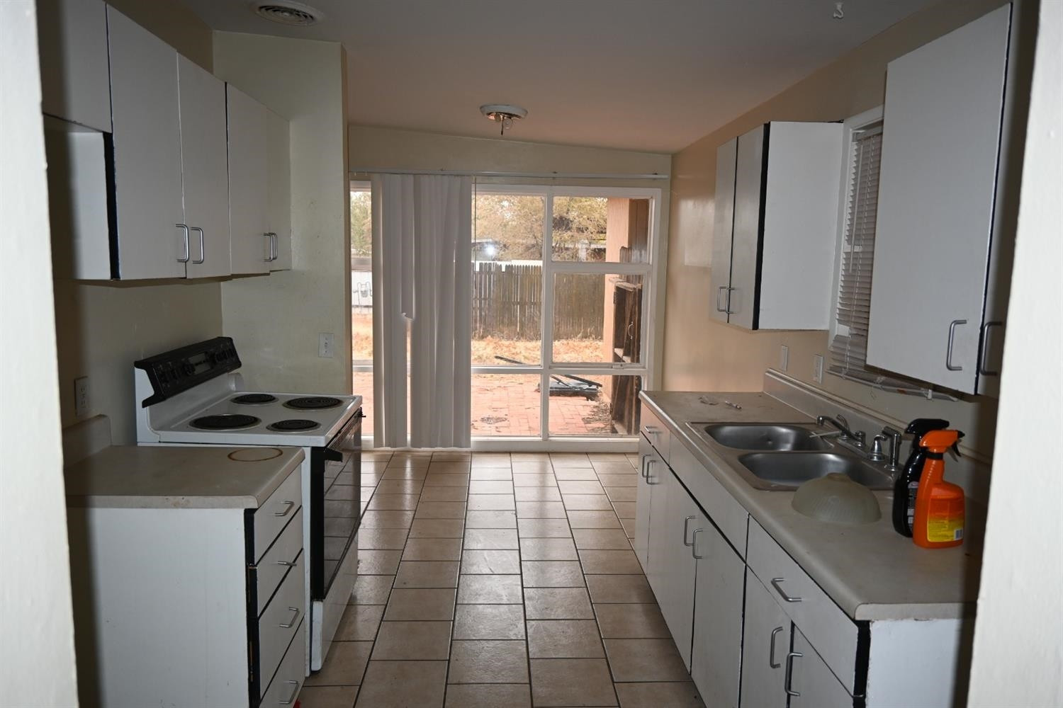 2725 62nd Street Lubbock, TX 79413 - Photo 2 of 11 a kitchen with stainless steel appliances granite countertop a stove a sink and a refrigerator