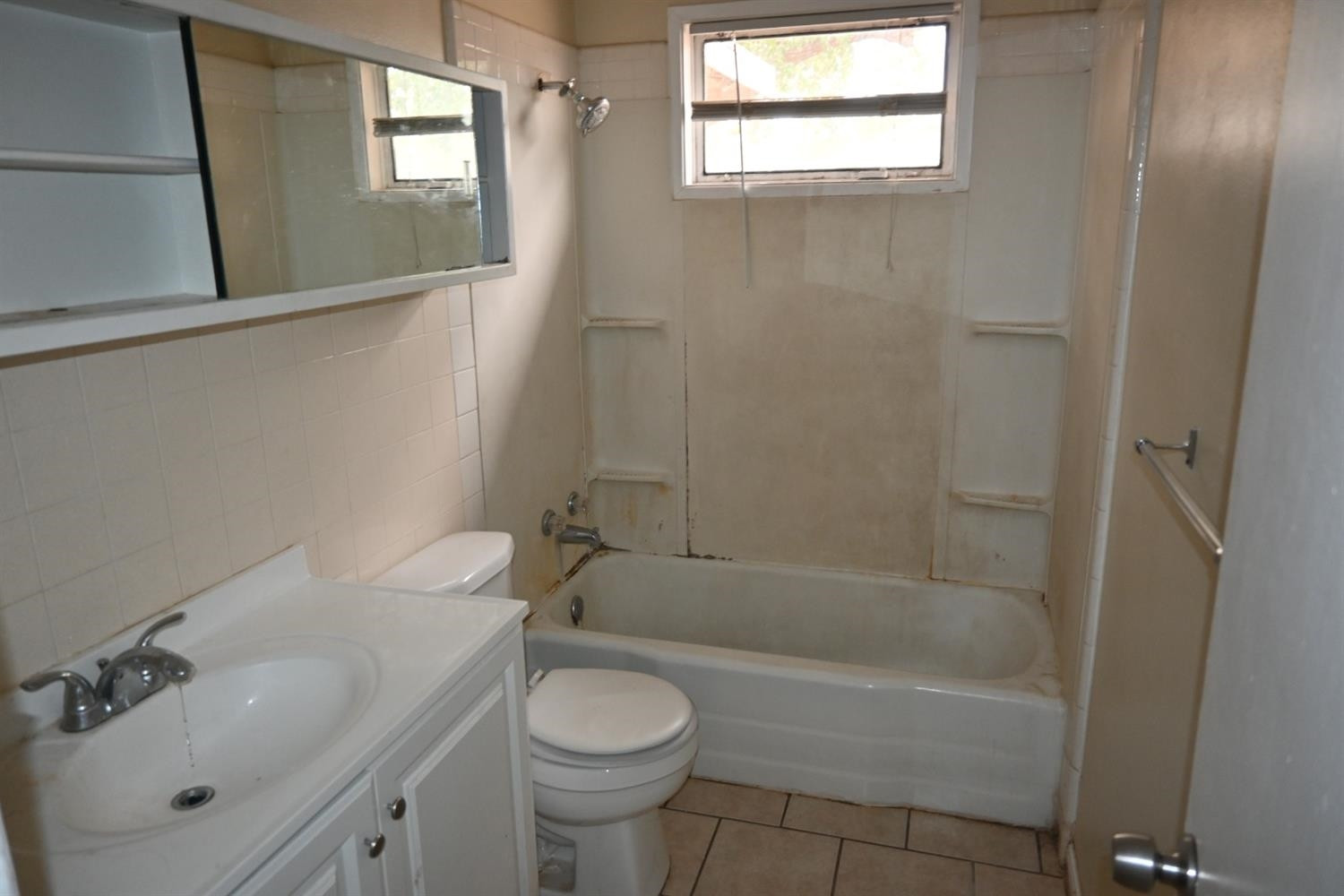 2725 62nd Street Lubbock, TX 79413 - Photo 7 of 11 a bathroom with a sink a toilet and shower
