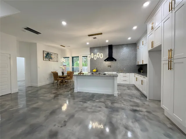 a bathroom with a granite countertop double vanity and a mirror
