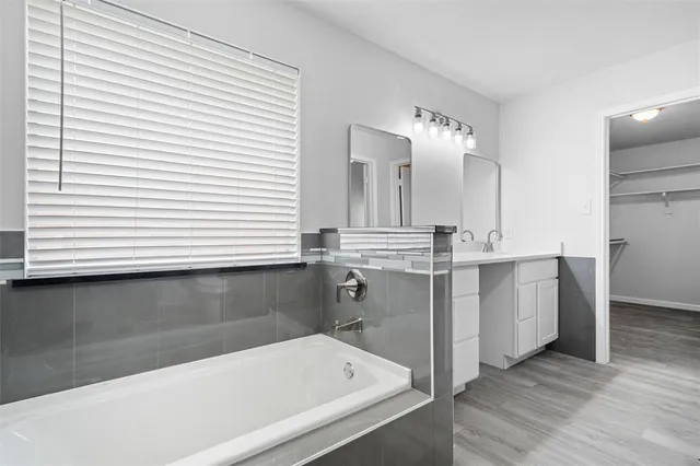 a bathroom with a bathtub and a sink
