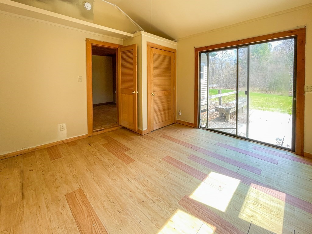 1430 Old Rte 9 Windsor, MA 01270 - Photo 8 of 14 a view of an empty room with wooden floor and a window