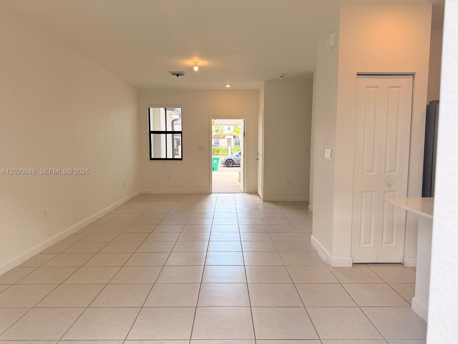 12875 Southwest 231st Terrace Miami, FL 33170 - Photo 7 of 25 a view of hallway with a window and a refrigerator