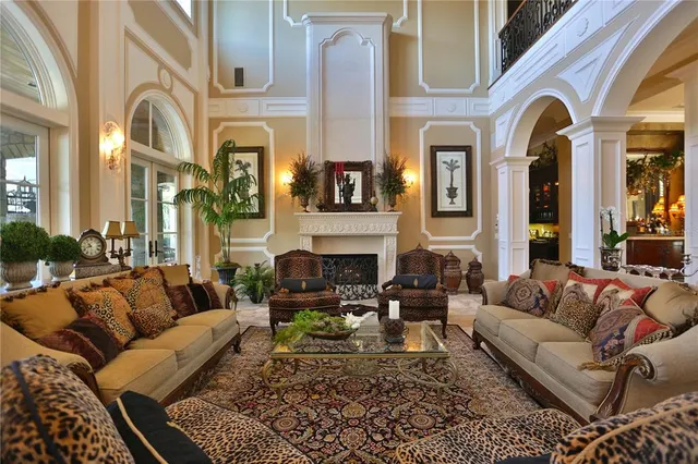 a living room with furniture a large window and a fireplace