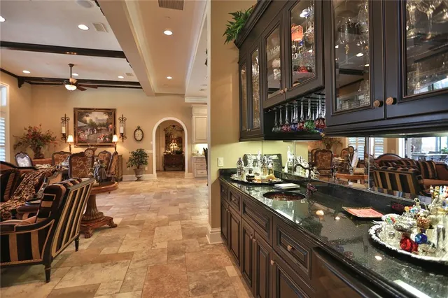 a kitchen with stainless steel appliances granite countertop a sink a stove and a wooden cabinets