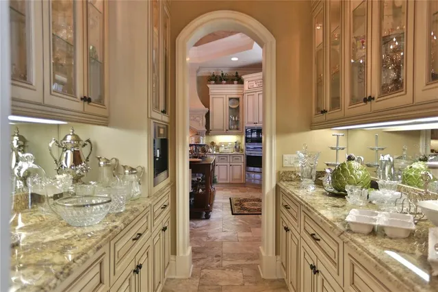 a living room with furniture a chandelier and fireplace