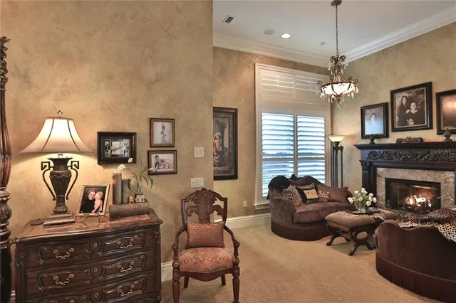 a view of a house with a large window and a yard with table and chairs