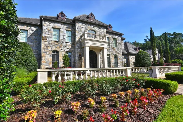 a view of a house with swimming pool and sitting area
