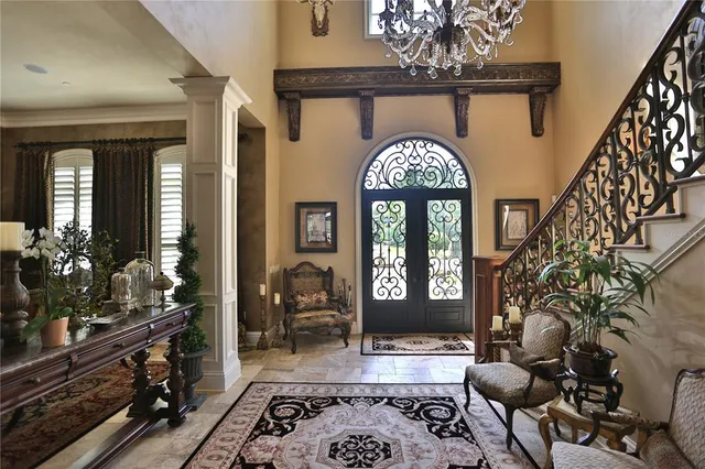 a living room with furniture and a chandelier