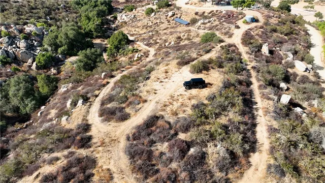 an aerial view of house with yard and mountain view in back