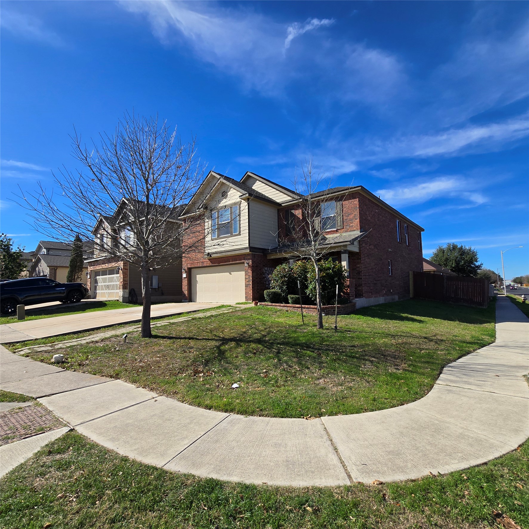 8900 Ridgewell Road Austin, TX 78747 - Photo 1 of 1 Traditional home featuring brick siding, a garage, and concrete driveway