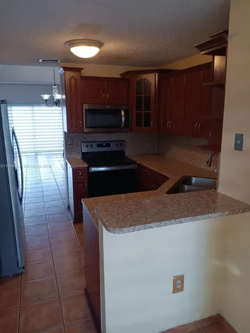 a kitchen with a sink and a refrigerator