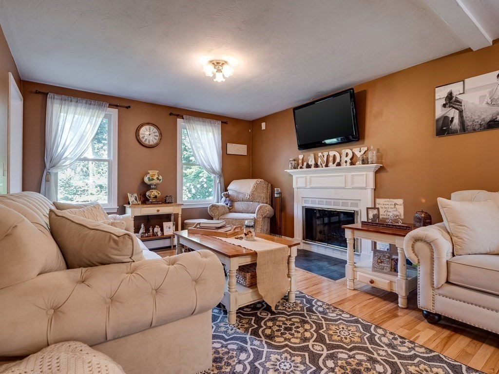 75 A Hazen Road Shirley, MA 01464 - Photo 9 of 42 a living room with furniture a fireplace and a large window
