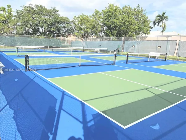 a room with pool table and windows