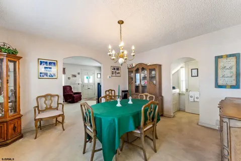 a view of a dining room with furniture and chandelier