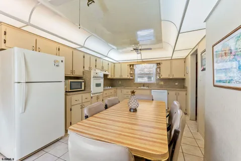 a kitchen with stainless steel appliances a refrigerator sink and cabinets