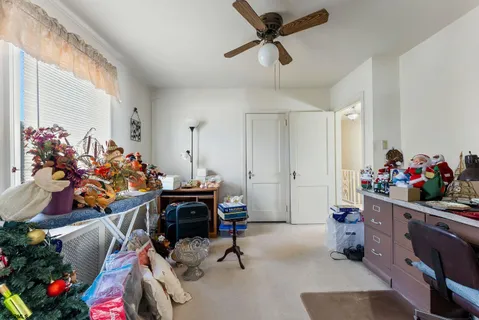 a view of a room with workspace and a window