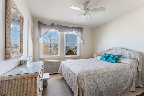 a bedroom with a large bed and a large window