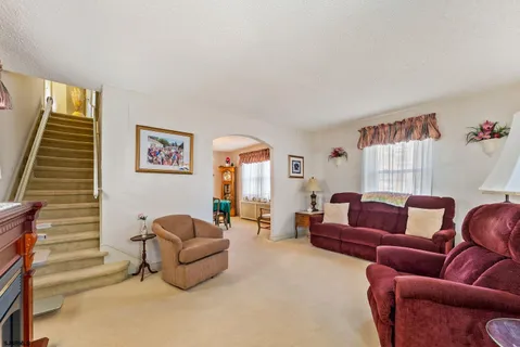a living room with furniture and a potted plant