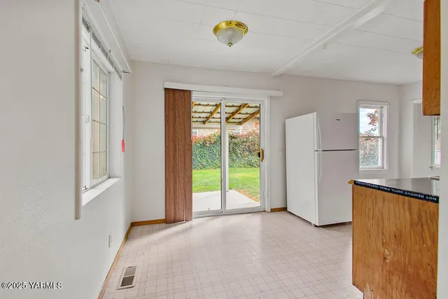 a view of a room with a window and a kitchen