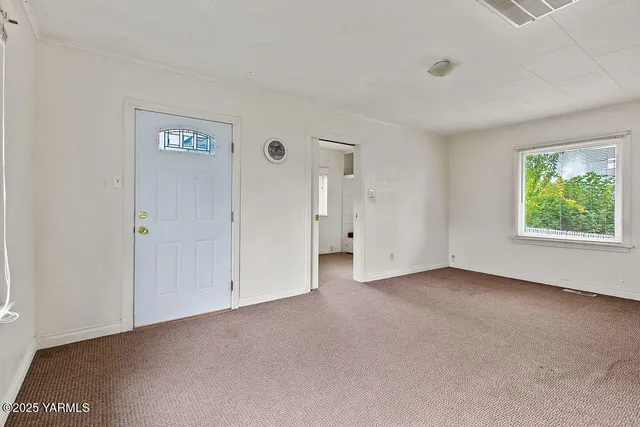 an empty room with windows and closet