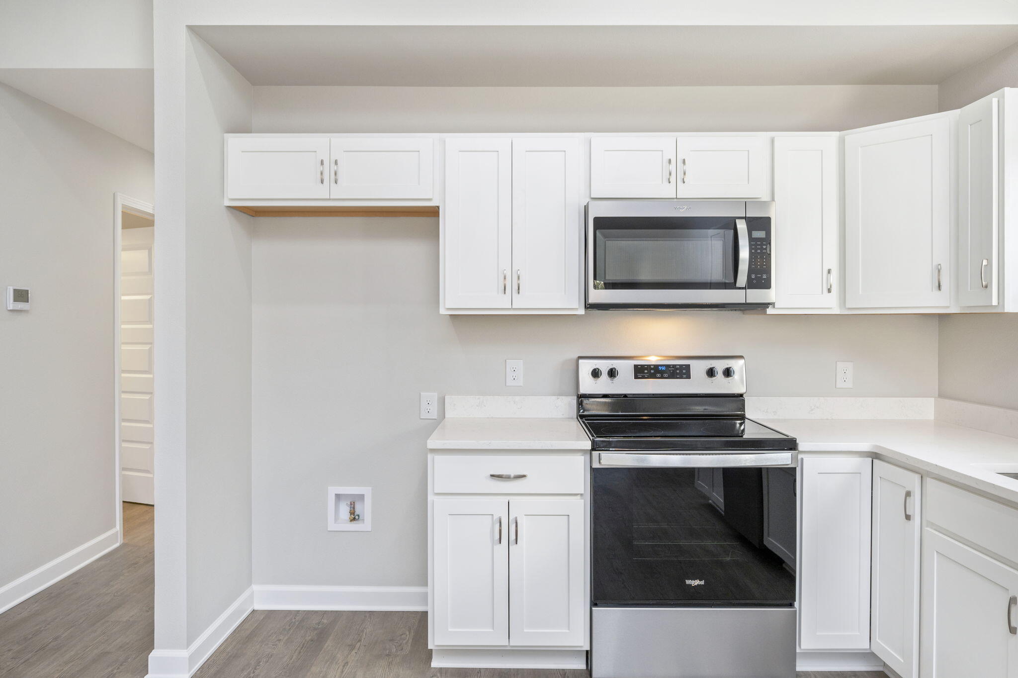 1000 Valley Road Crestview, FL 32539 - Photo 12 of 30 a kitchen with white cabinets and stainless steel appliances