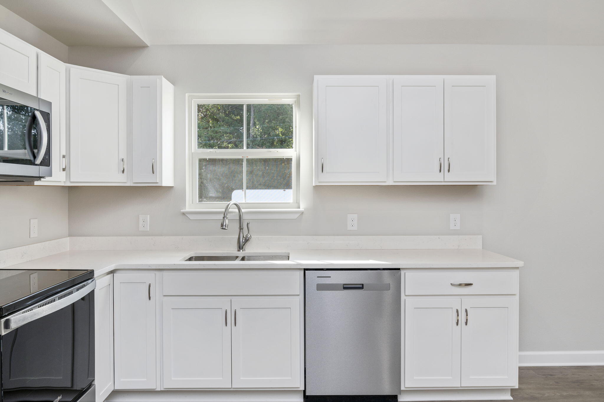 1000 Valley Road Crestview, FL 32539 - Photo 13 of 30 a kitchen with white cabinets and white appliances