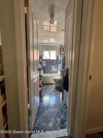 a view of a hallway with a dining room view
