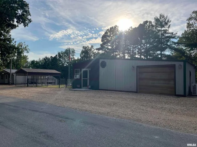 a kitchen with a table chairs refrigerator and microwave
