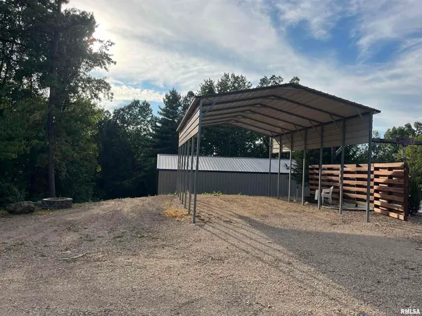 a view of a house with a yard and tree