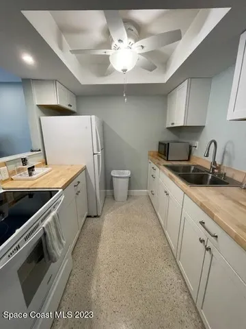 a kitchen with a sink appliances and cabinets